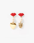 Pair of earrings with red lip-shaped tops, pearl beads, and gold heart and lion head charms on a white background.