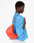 Lune Purse being worn on model's shoulder