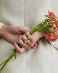 groovy diamond heart signet ring on pinky finger on a model holding flowers