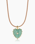 Heart-shaped green pendant necklace with rose gold chain on a white background