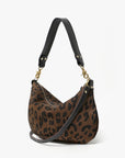 Leopard print handbag with black handle and strap on a white background