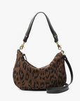Leopard print handbag with black handle and strap on a white background