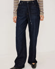 denim tie waist pant worn by a model with a stripe shirt on a grey background