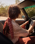 Woman driving a car with a scenic background