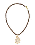 Necklace with brown beads and a shell pendant on a white background