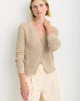 Raleigh Cardigan in Latte close up front view on model with one of her hands behind her neck