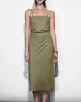 Woman wearing a green dress against a white background