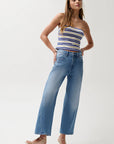 Woman wearing a striped top and blue jeans on a white background, full body front