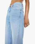 Light blue jeans worn by a person on a white background