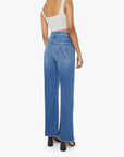 Woman wearing blue jeans and a white top on a white background