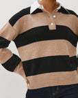 Person wearing a beige and black striped sweater with a white collar.