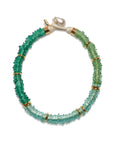 Green beaded bracelet with gold accents on a white background