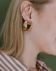 Adriana Pappas Puffed Heart Studs in Gold on model