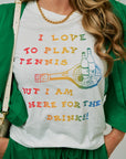 Person wearing a white t-shirt with colorful text and graphics, standing against a neutral background with Mercer Necklace