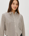 Woman wearing a striped shirt against a plain background front view