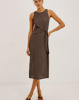 Woman wearing a brown and black striped dress on a white background