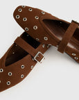 Brown leather sandals with eyelets and buckles on a white background