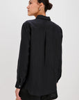 Person wearing a black shirt and shorts on a white background back view