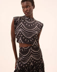 inah stranded pearls top with yara skirt on a model with a cream background