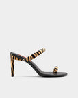 High-heeled sandal with zebra print straps on a white background