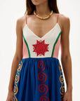 Woman wearing a dress with colorful patterns on a white background