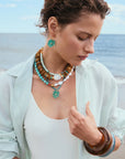 Woman wearing colorful jewelry on a beach