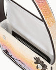 Close-up of a handbag with a palm tree design and beaded strap.