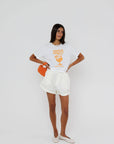model wearing amalfi spritz short sleeve tee with white shorts on a white background