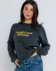 Woman wearing a dark gray sweatshirt with 'Amalfi Coast 1970 Italy' text against a light background