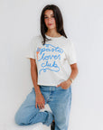 Woman wearing a 'pasta lover club' t-shirt and jeans against a white background