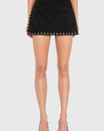 Model wearing black skirt with studs on White background
