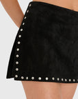 Model wearing black skirt with studs on White background