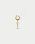 Gold fish-shaped earring on a light gray background
