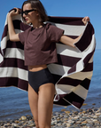The Cropped Perfect Tee in Chocolate with striped beach towel