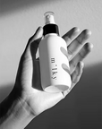 Riddle Voyeur Spray Lotion | 4ounce Spray Lotion in hand