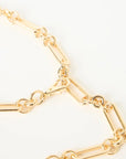 Gold chain belt on a light beige background