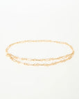 Gold chain belt on a light beige background