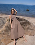 The RSVP Dress, model leaning against rock