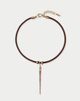 Brown leather necklace with gold accents on a light gray background