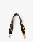 Black leather strap with gold hardware on a white background