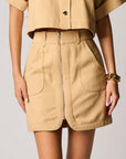 Beige skirt with a zipper on a plain background