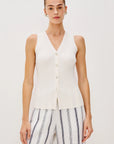 Woman wearing a white sweater vest shirt on a white background front view