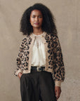model wearing the leopard windsor cardigan with a cream top and jeans cream background, front