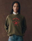 The College Sweatshirt Rodeo Star Graphic on a model with jeans brown background, front view