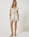 Woman wearing a white romper on a white background