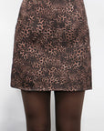 Leopard print skirt worn by a person on a white background