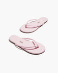 Pair of pink flip-flops on a white background
