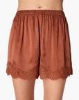 Brown satin shorts with lace trim on a white background