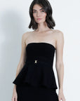 Woman wearing a black strapless peplum dress against a white background front view