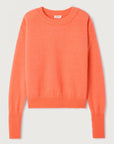 Orange sweater on a light gray background